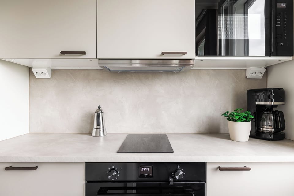 Modern, well-equipped kitchen with coffee station and sleek appliances