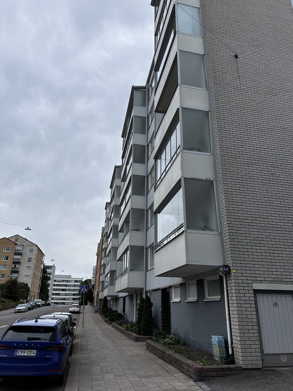 Modern city apartment exterior on a quiet, well-kept street