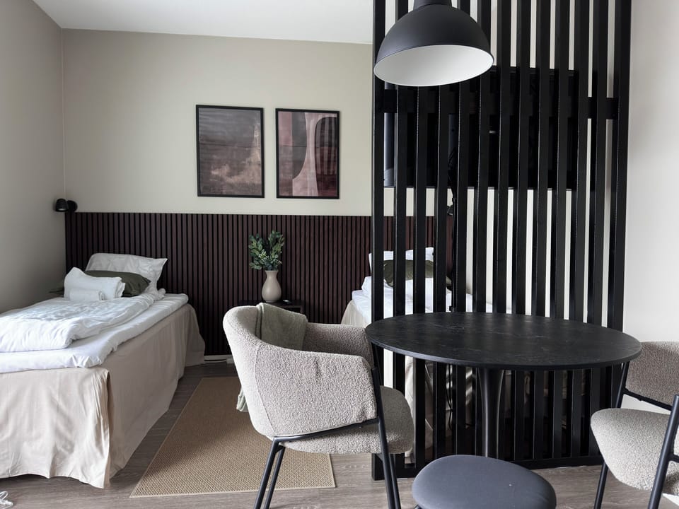 Modern studio retreat with chic divider and cozy dining nook