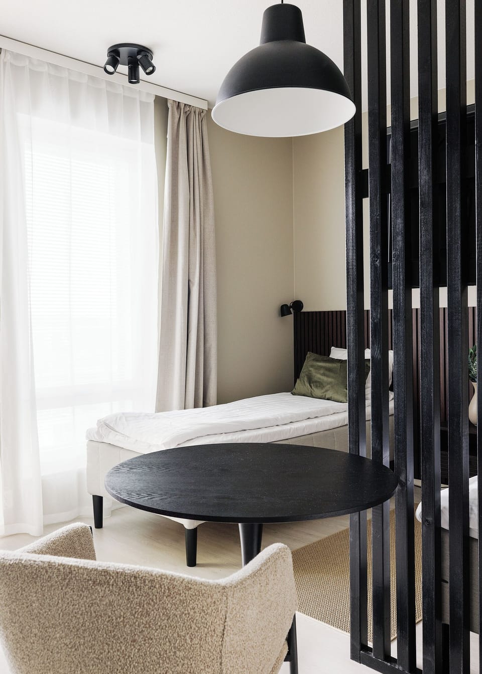 Bright modern sleeping nook with chic divider and cozy seating area