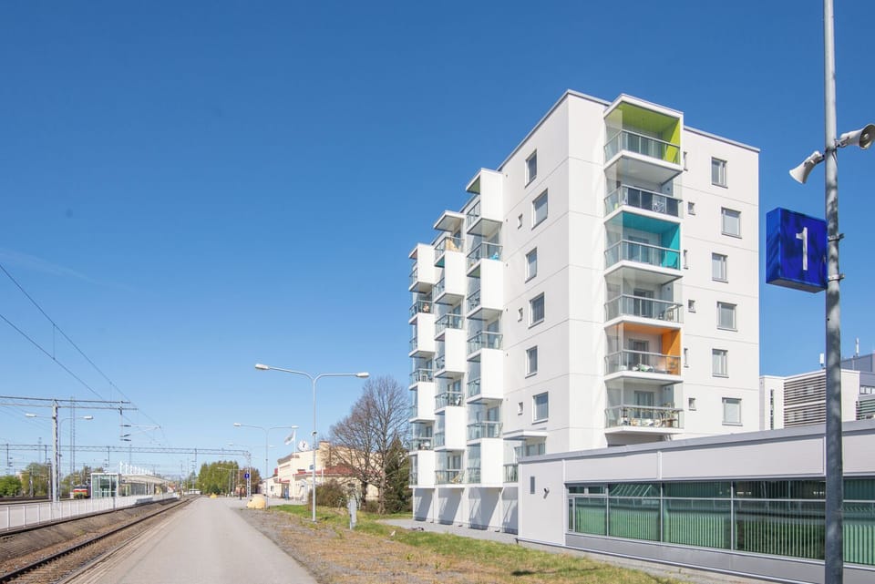 Modern apartment building with colorful balconies and convenient transit access