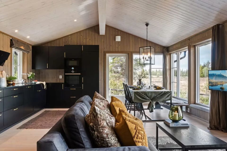 The kitchen and dining area has large windows that tak in the nature