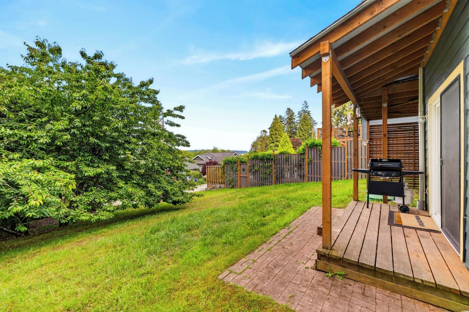 Private patio with a gas grill and grassy outdoor space for relaxing between adventures.
