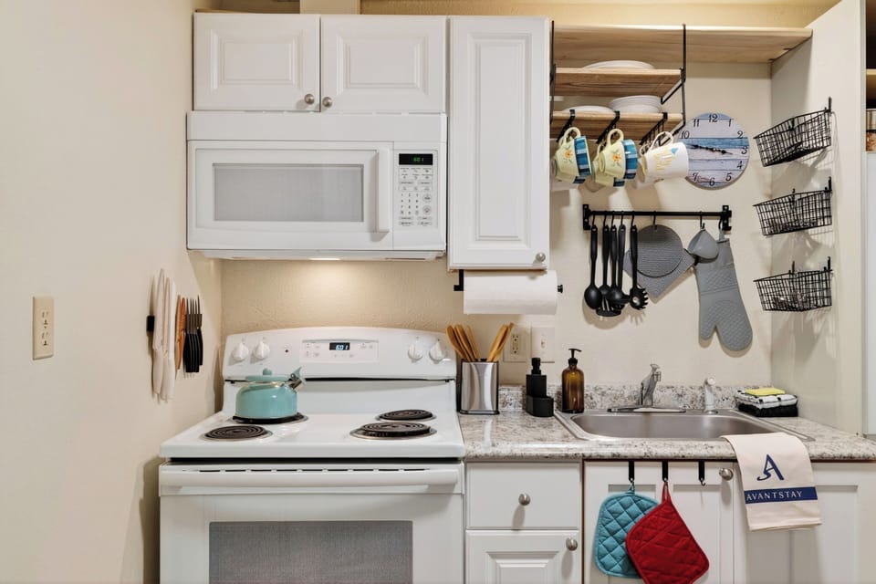 Compact kitchen stocked for simple meals during your Whidbey Island stay.