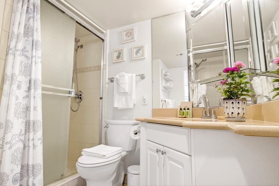 Clean and bright master bathroom featuring a large vanity and walk-in shower.