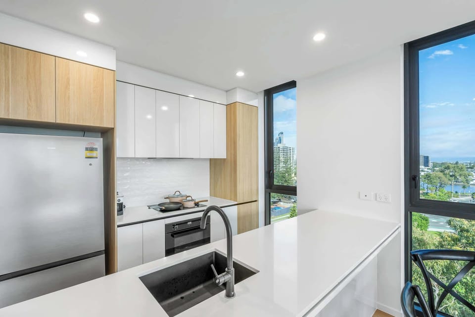 Modern kitchen with breakfast island and river views.