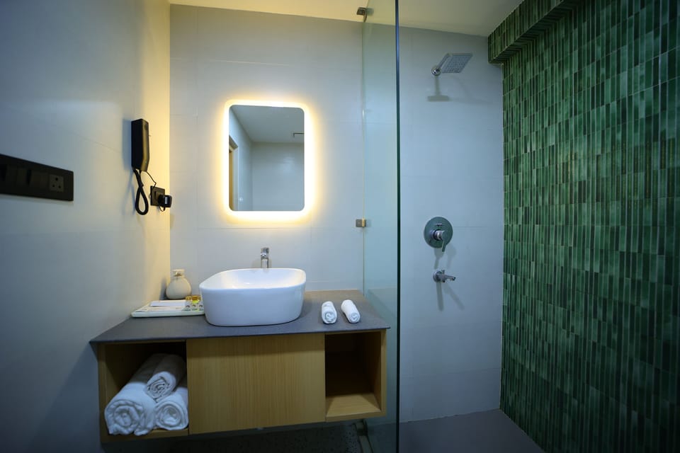 Premium Double Room, 1 King Bed | Bathroom | Shower, slippers, towels, soap