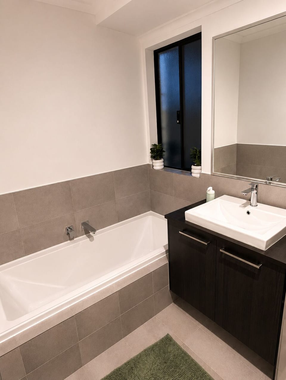 Enjoy a bright, modern bathroom featuring a full-size bathtub and contemporary finishes—the perfect place to refresh after a day of exploring or relax with a long soak.