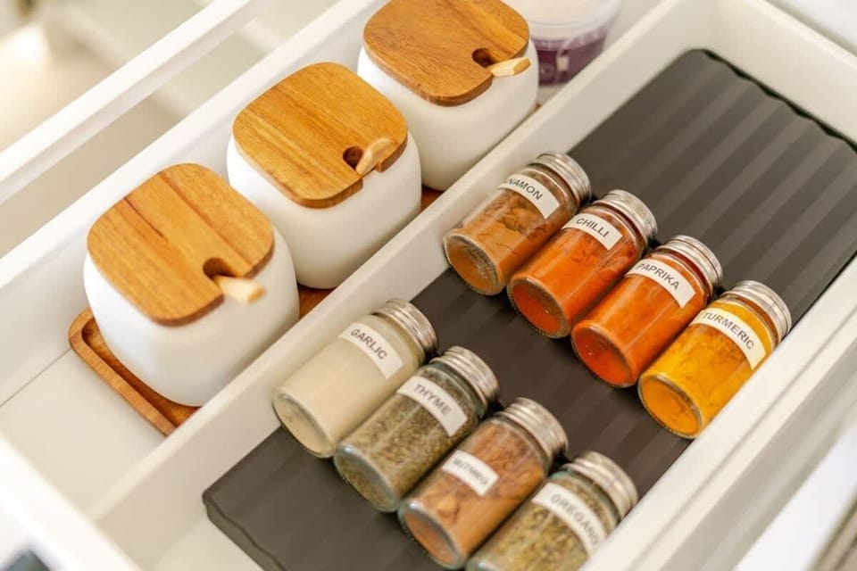A fully stocked spice drawer with curated essentials for cooking. The kitchen also features premium Zwilling chef’s knives, pans, and tools—perfect for preparing flavorful meals in this chef’s kitchen