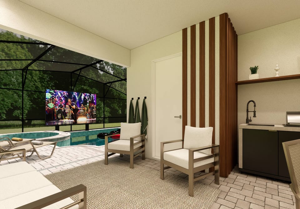 Relax in this stylish lounge area featuring comfortable seating and a tastefully designed kitchenette. Large glass doors invite natural light and offer a seamless flow to the inviting outdoor space, perfect for unwinding.