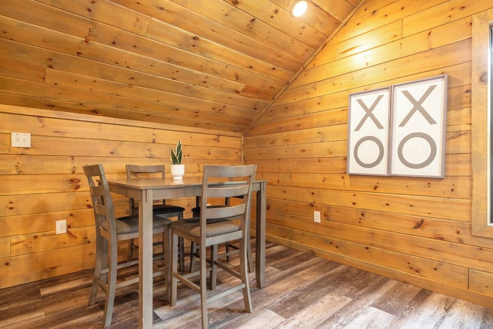 Gather around your private dining table beneath warm wood ceilings, where every meal feels like a cozy retreat in your cabin-style escape.