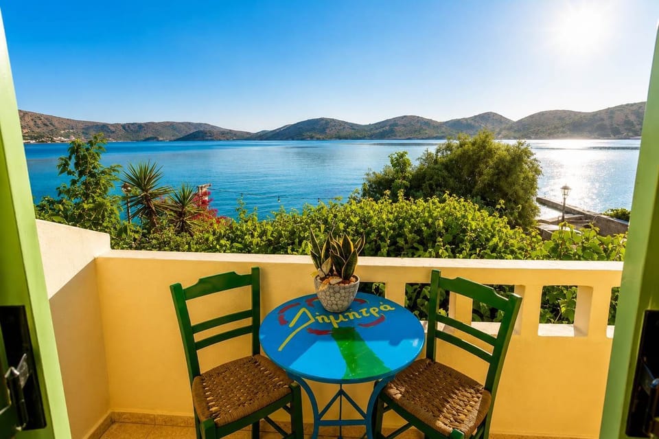 Balcony seating area with a relaxing view toward the sea.