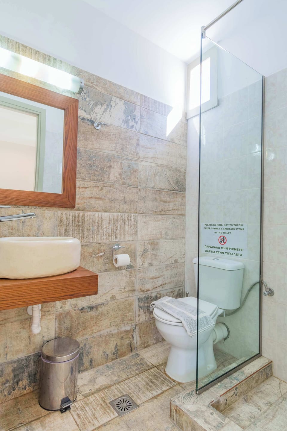 Aphrodite: Modern bathroom with glass shower and bright, clean finishes.
