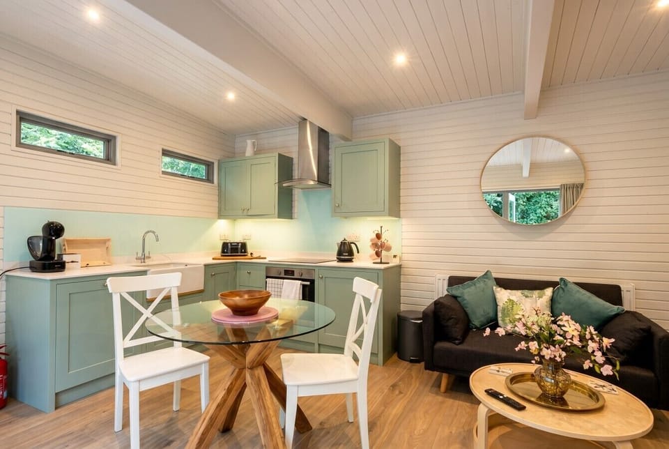 Sage green kitchen and dining nook bright with natural light