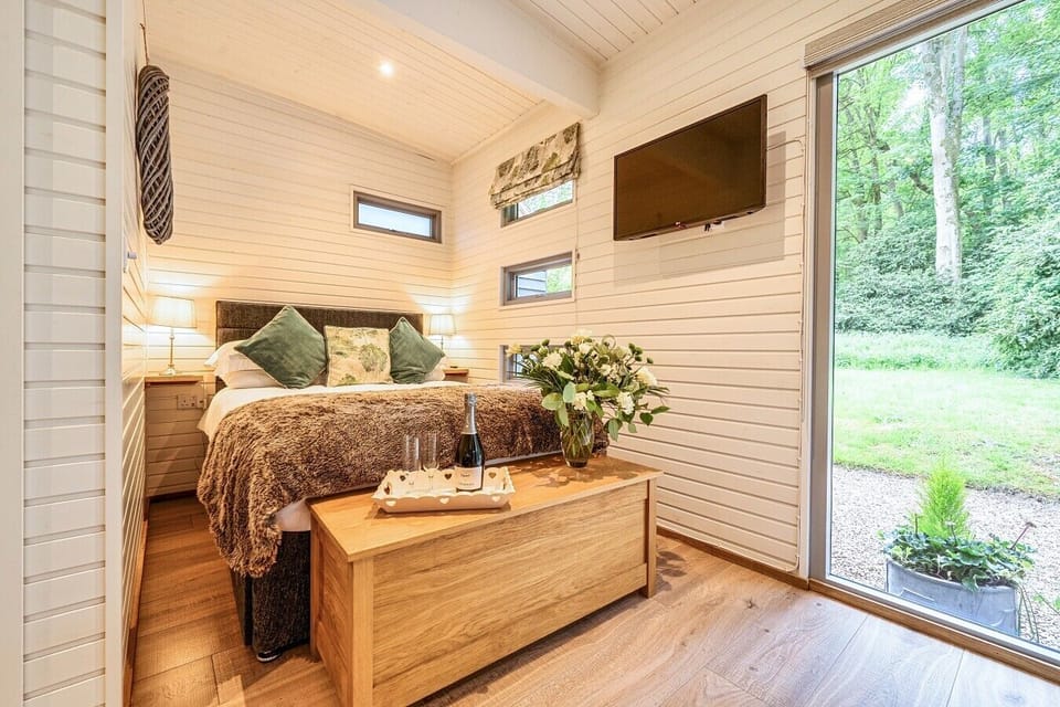 Hotel-standard double bed with a smart TV and garden views to wake to