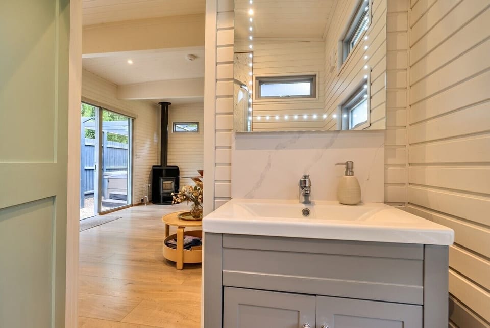 Bright vanity with a glimpse back to the wood burner beyond