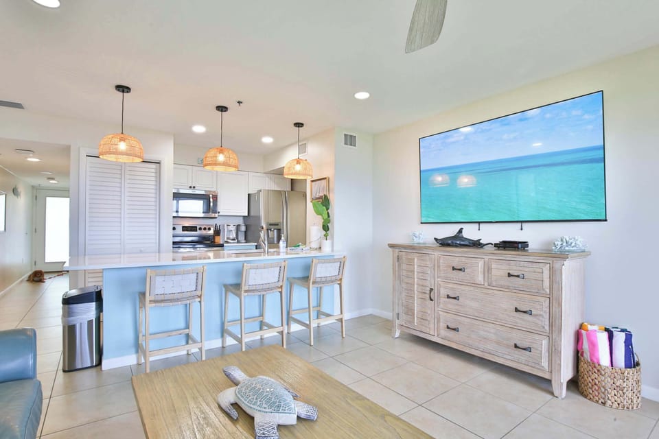A massive TV, open living space, and the kitchen steps away — movie nights and game days are ready for you!