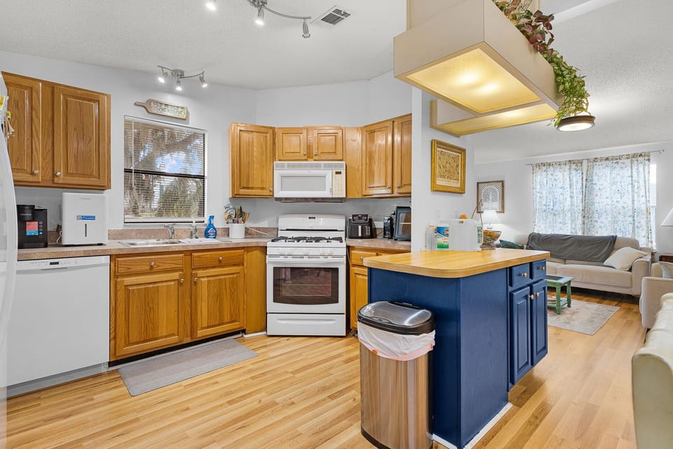 Your fully equipped kitchen features warm wood cabinetry, stainless appliances, and a convenient breakfast island—perfect for preparing meals and gathering with loved ones.