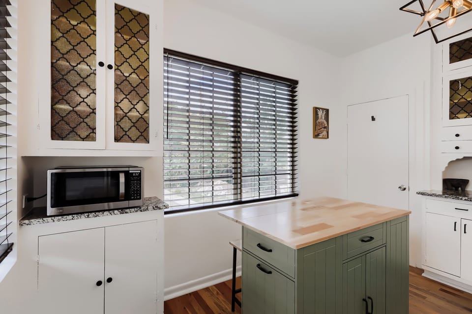Your bright, fully-equipped kitchen awaits with modern appliances, a charming island workspace, and stylish details—perfect for preparing meals during your stay.