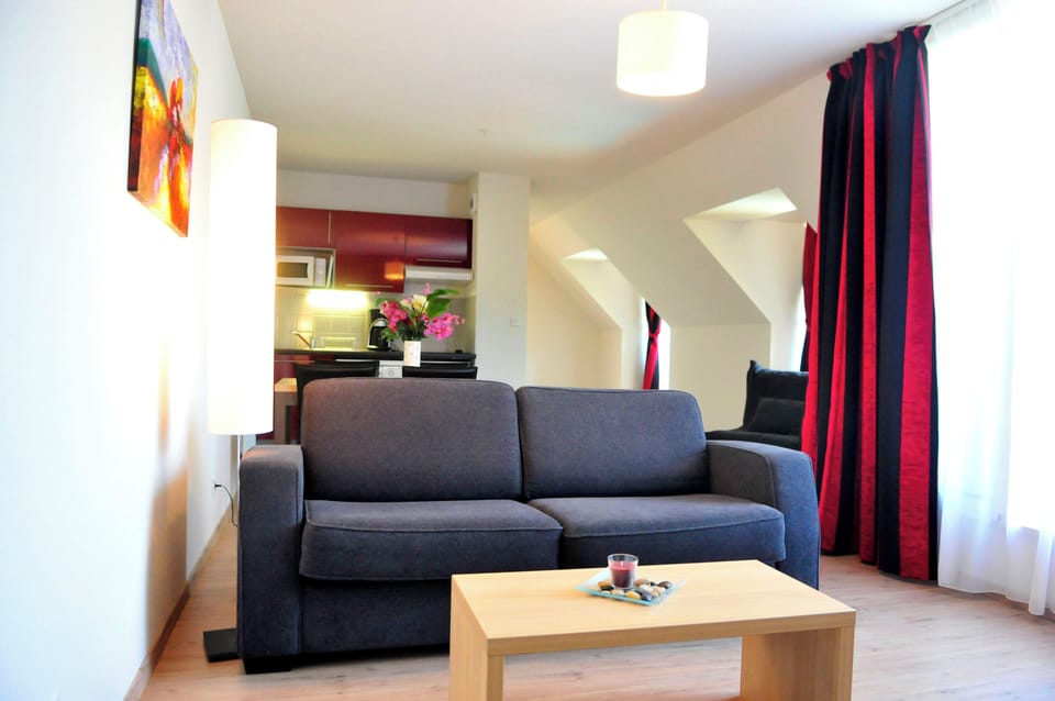 The cosy living area with sofa bed and coffee table — the cabin-style layout makes great use of every m² for families staying in the Aveyron.