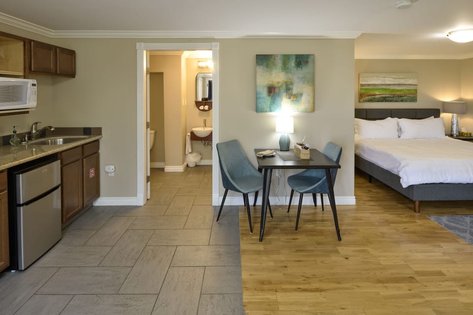 Suite, 1 King Bed, Jetted Tub | Private kitchen | Fridge, coffee/tea maker, electric kettle, cookware/dishes/utensils