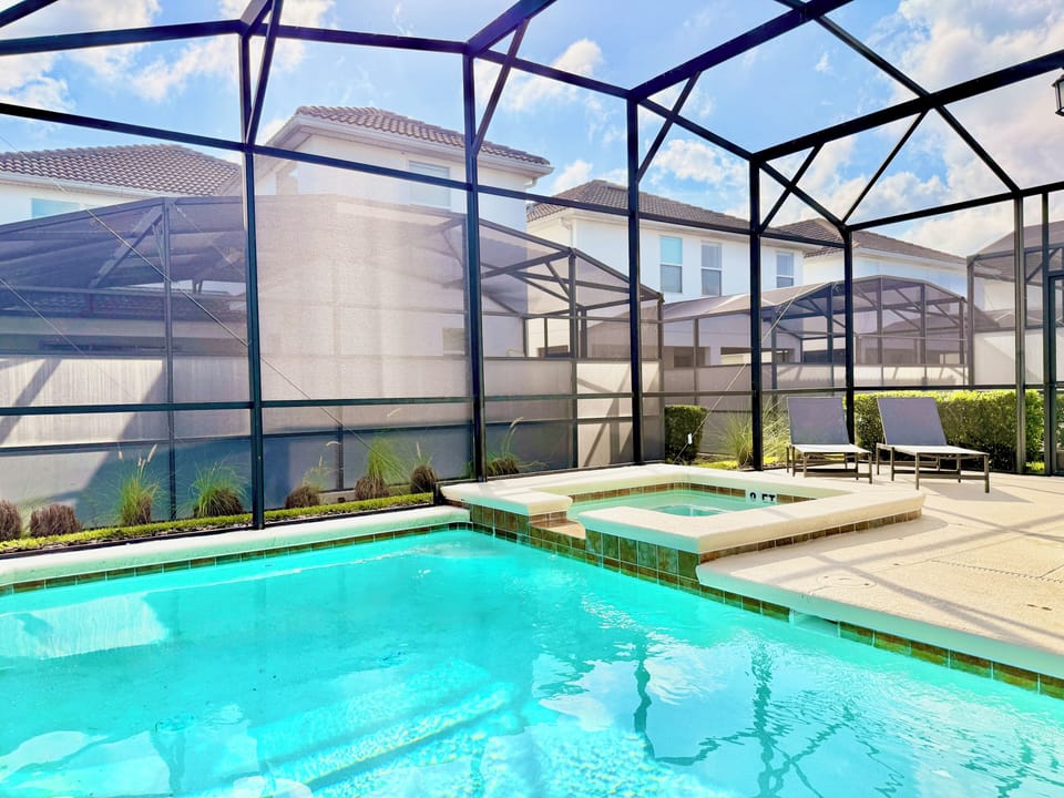 Sunny pool deck enclosure equipped with comfortable mesh lounge chairs.