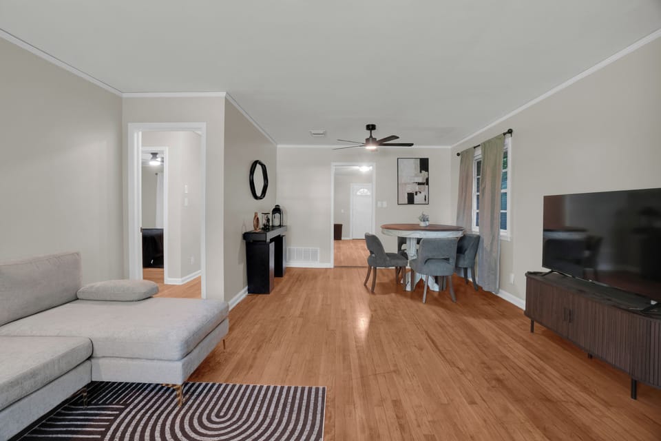 Bright open living and dining space with modern style and warm wood floors