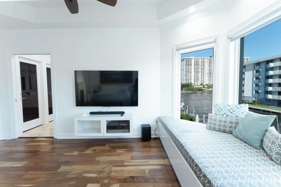 Large Smart TV and cozy window seating create a relaxing retreat.