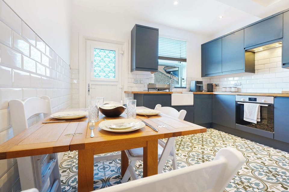 Right next to the kitchen, this inviting dining setup features a table with seating for four guests. It offers a highly practical and welcoming space for enjoying your meals, sharing good conversations, or planning out the day ahead.