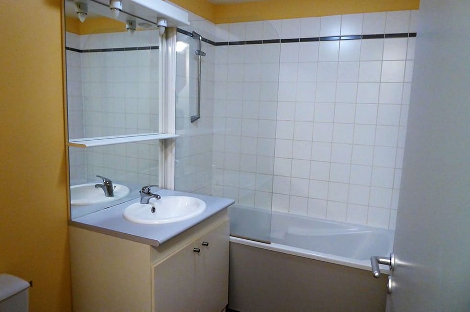 Bathroom with shower and basin — compact and clean.