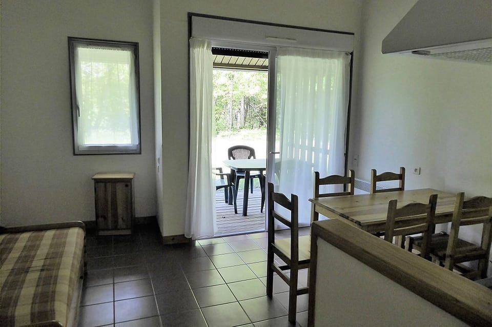 Open-plan living and dining area with natural light and access to the terrace.