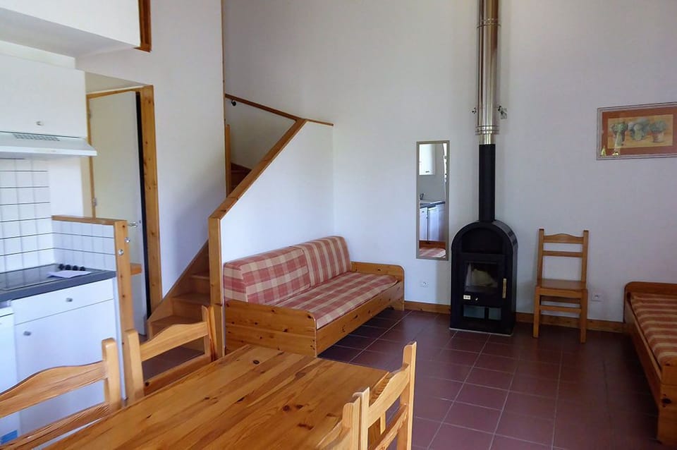 Wood stove in the living area for cooler evenings, with the dining table alongside.