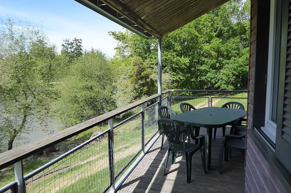 Covered terrace with lake views — a natural spot for breakfast or an evening drink.