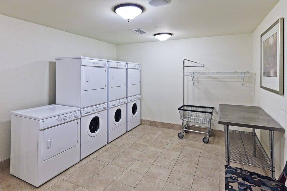 Washer and dryer units in the shared laundry room, available at no extra charge throughout your stay