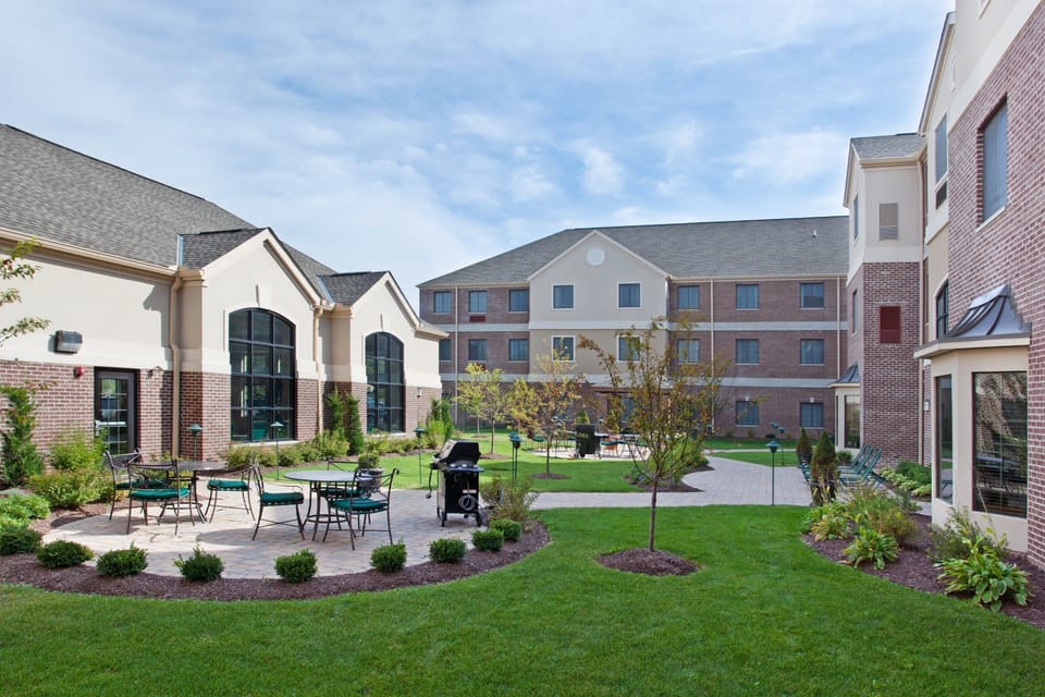 Landscaped courtyard with seating areas and walkways — a relaxed space to sit and unwind outdoors