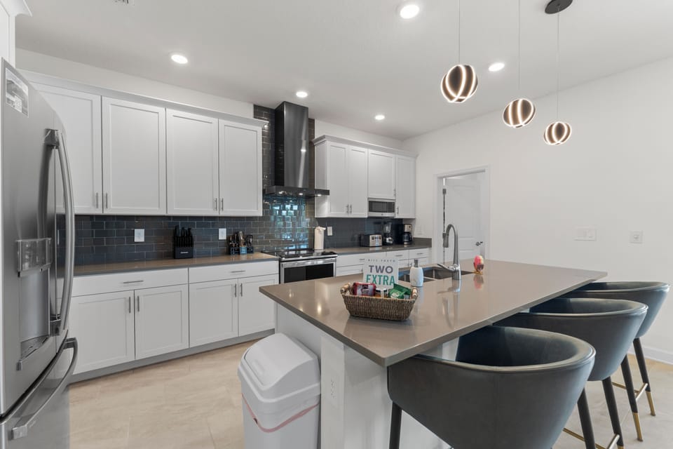 Modern chef’s kitchen with island seating for four and sleek finishes