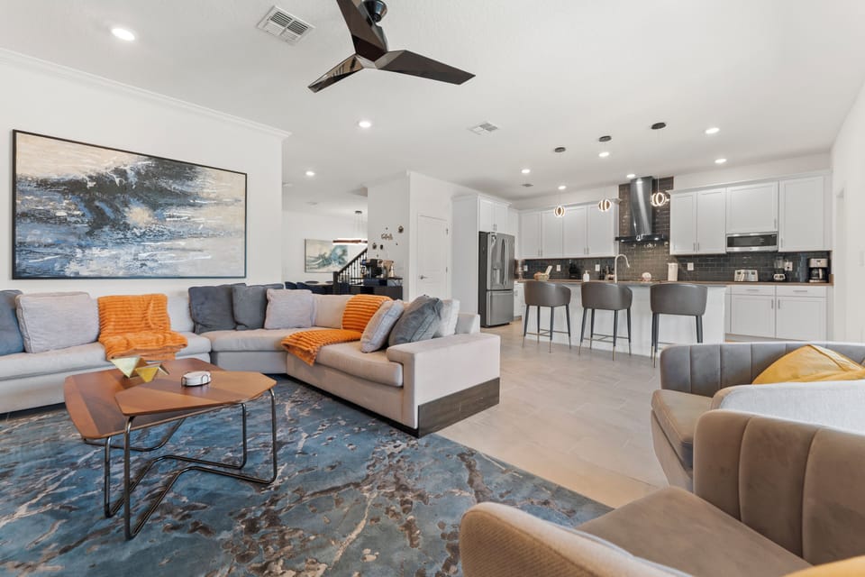 Bright open-concept living room and sleek kitchen with island seating