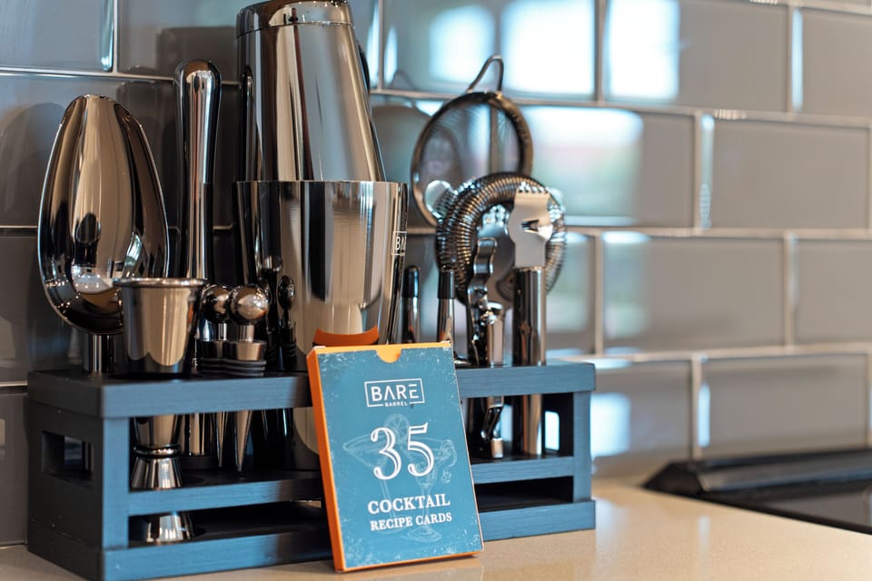 Stylish in-home cocktail station with sleek bar tools and recipe cards
