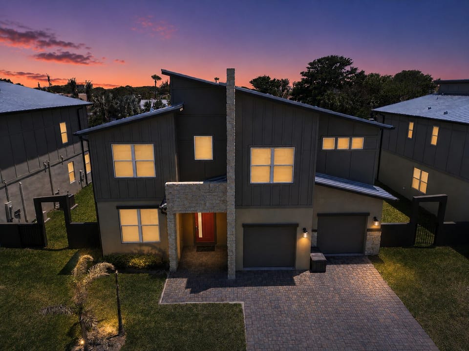 Modern twilight exterior with bold architecture and inviting curb appeal