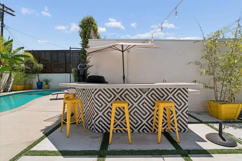 Outdoor kitchen area with bar seating where your group chef is going to cook up a marvelous meal for you guys.