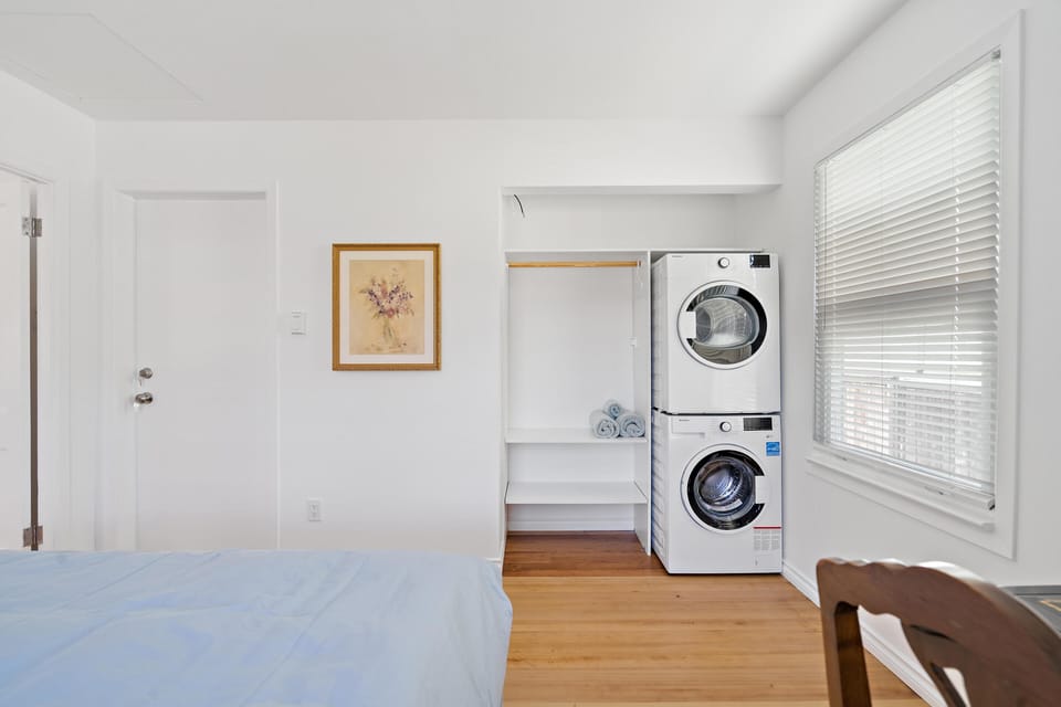 In-suite laundry convenience featuring a stacked full-sized washer and dryer inside the bedroom alcove.
