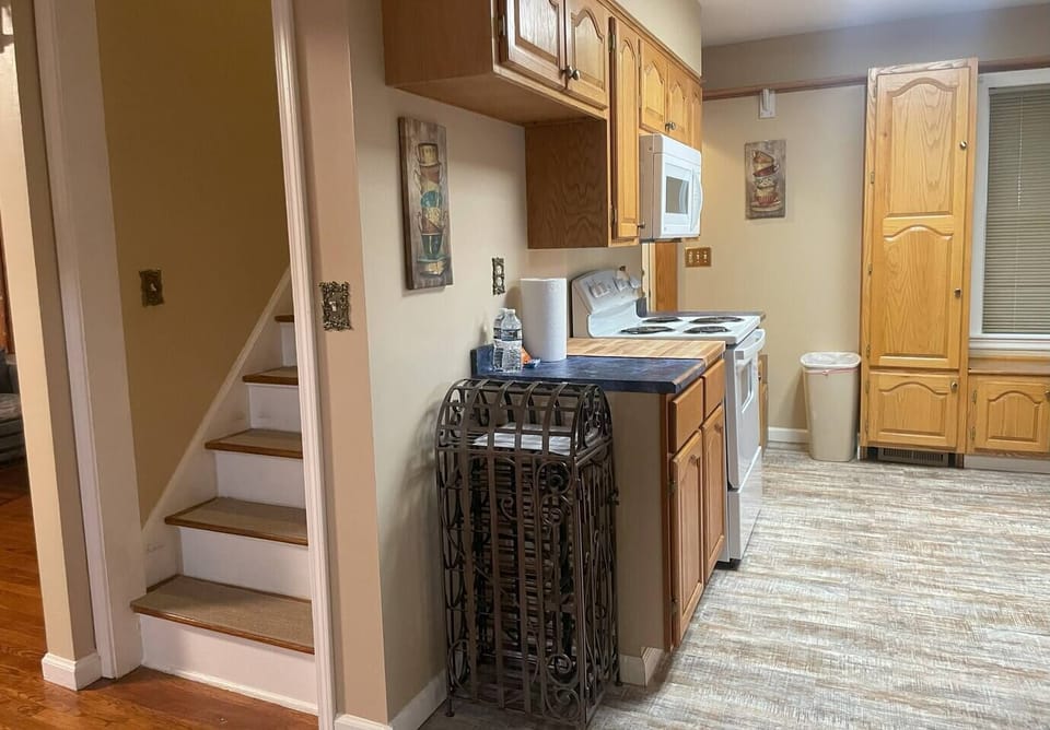 Kitchen - refrigerator, dishwasher, wine rack, and butcher's board.