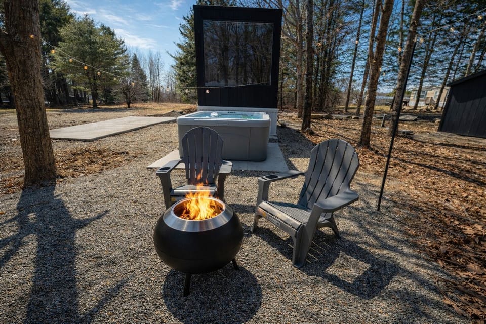 Forest retreat with hot tub, smokeless fire pit, and string-lit patio