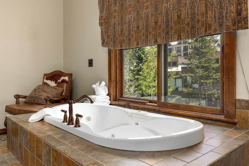 Soaking tub in master bedroom with great views | Main Level