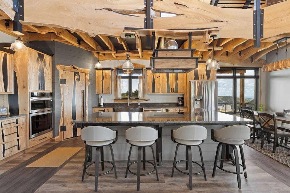 A unique wood-styled kitchen featuring a beautifully crafted island blends warm natural textures with modern design, creating a stylish and inviting space for cooking and gathering.