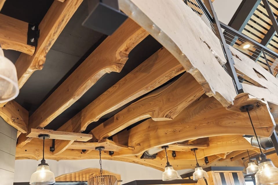 A striking ceiling with unique wood design details that adds warmth, texture, and a modern rustic character to the space.