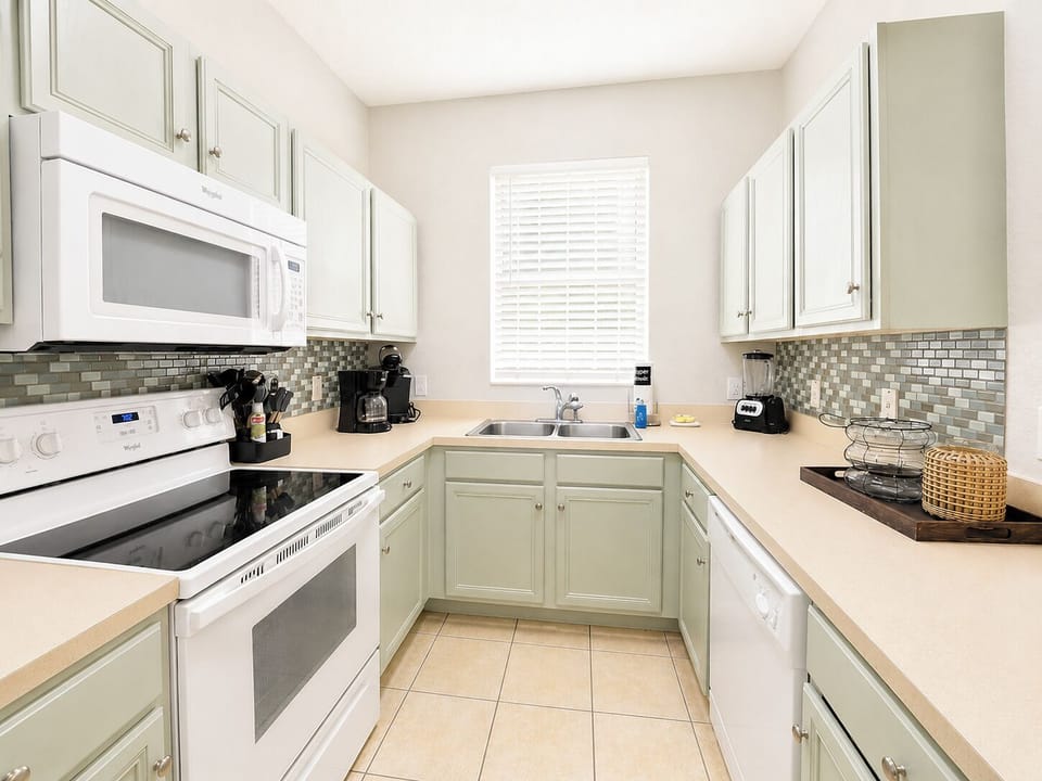 Fully equipped kitchen showing sink area and oven.