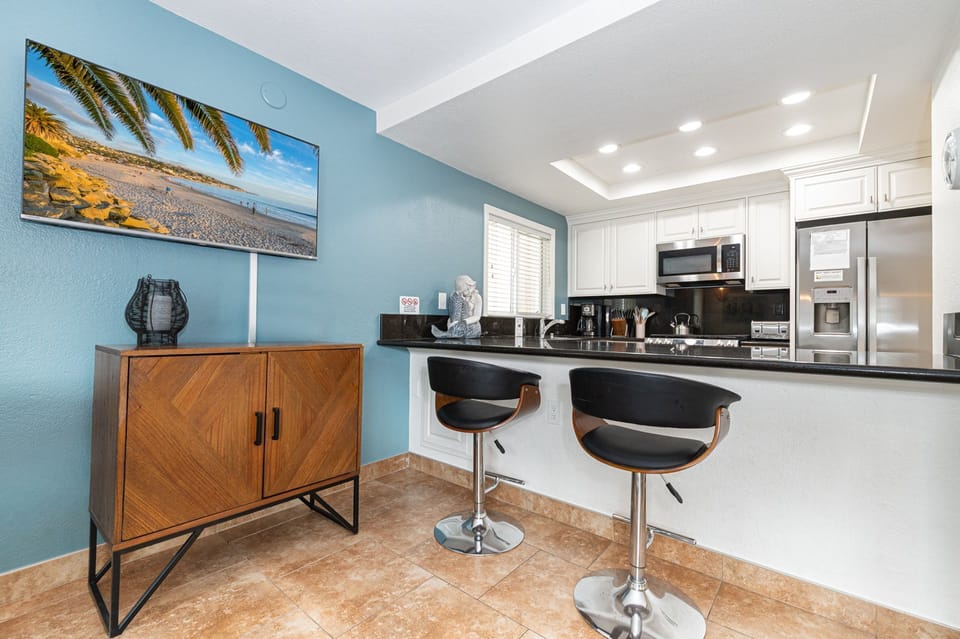 Open kitchen layout with granite countertops and convenient breakfast bar seating
                