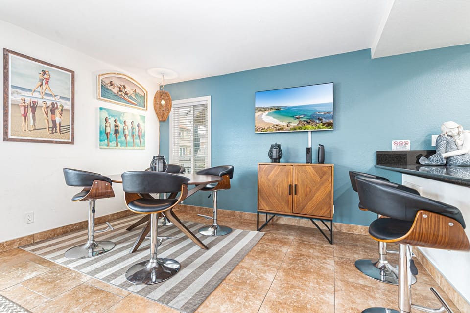 Dining area with seating for 4 and additional bar seating at the kitchen counter
                