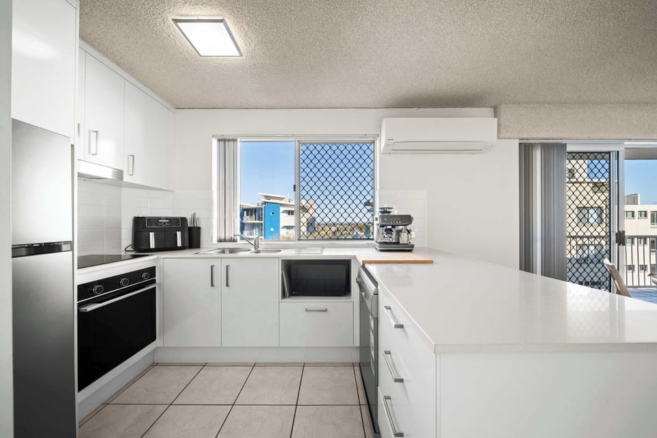 Modern kitchen featuring a Breville coffee machine for morning coffee